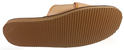 Three-quarter view of men's handmade beige leather house slide showing crossover strap construction and flexible rubber sole – The Leather Gift Co