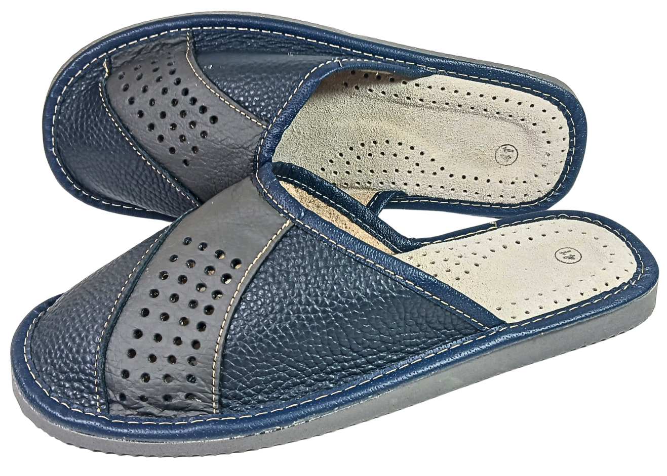 Pair of men's handmade leather slippers showing perforated upper and sheepskin insole, handmade in Poland
