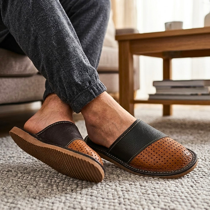 Side profile view of men's two-tone black and brown open-toe leather slipper with perforated toe panel and tan rubber outsole — The Leather Gift Co
