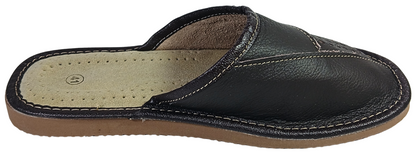  Lifestyle shot of man wearing dark brown closed-toe leather slippers on hardwood floor with grey trousers — The Leather Gift Co