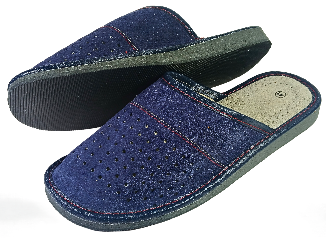 Pair of men's navy blue suede closed-toe slippers showing perforated upper and dark ribbed rubber outsole from three-quarter angle — The Leather Gift Co