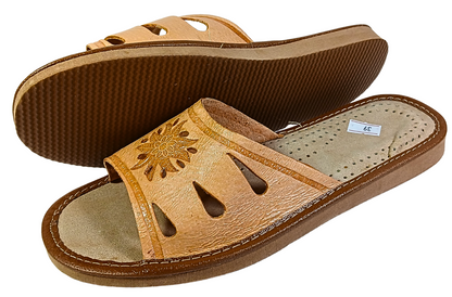 Tan leather women's slide slipper worn on foot — lifestyle indoor shot