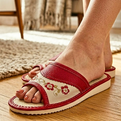 Red and cream leather slide slipper — front angle view showing open toe and rubber outsole
