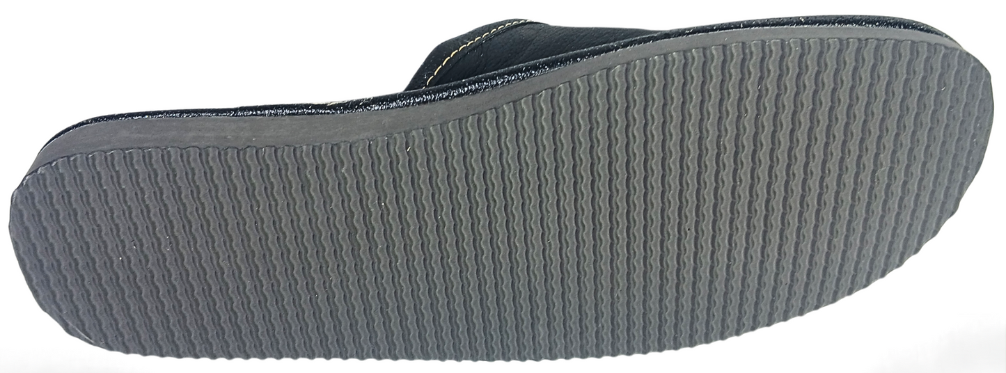 Sole view of men's black buffalo leather closed-toe mule slipper showing full grey ribbed rubber outsole with wave traction pattern — The Leather Gift Co