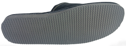 Sole view of men's black buffalo leather closed-toe mule slipper showing full grey ribbed rubber outsole with wave traction pattern — The Leather Gift Co