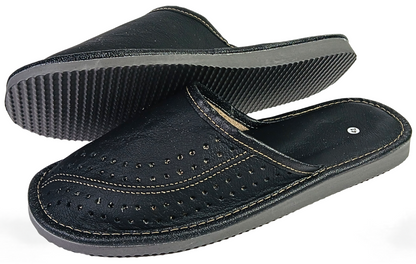 Pair of men's black buffalo leather closed-toe mule slippers showing perforated upper and grey ribbed rubber outsole from three-quarter angle — The Leather Gift Co