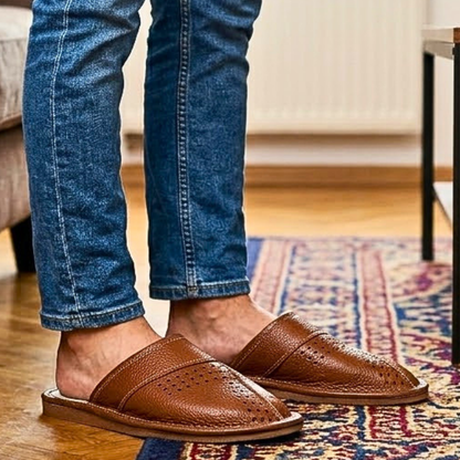Close-up side view of men's tan brown closed-toe leather slipper showing perforated dot cluster and white contrast stitching — The Leather Gift Co